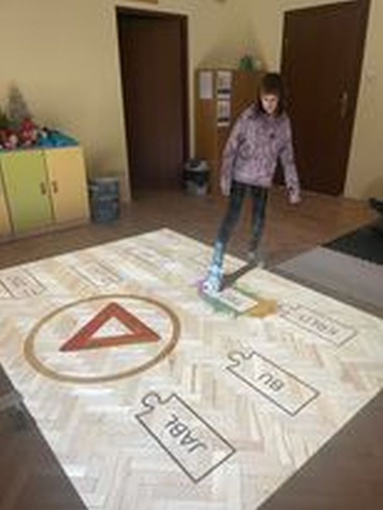 Uczennica dopasowuje wyrazy na dywanie interkatywnym.